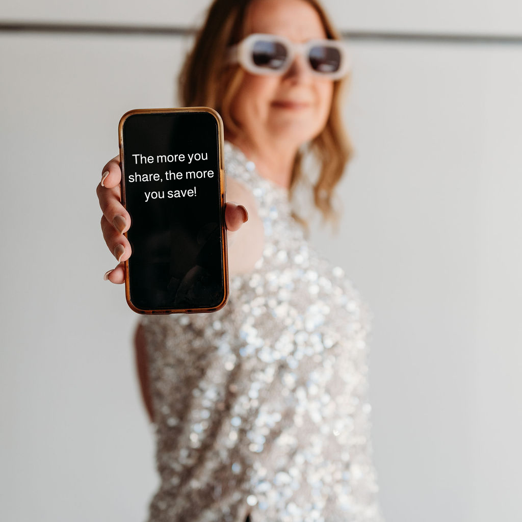 Founder angela holding a phone with the message the more you share the more you save